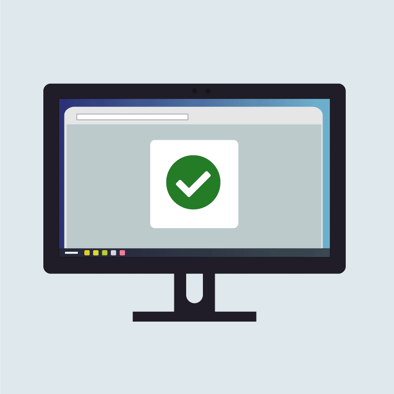 a computer monitor displaying a green circle with a white check mark inside of it