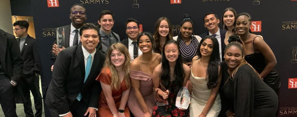 14 people smile for the camera
