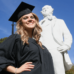 Photo of student in front of Sam Houston Statue for section named Student “Doesn’t Miss a Beat”