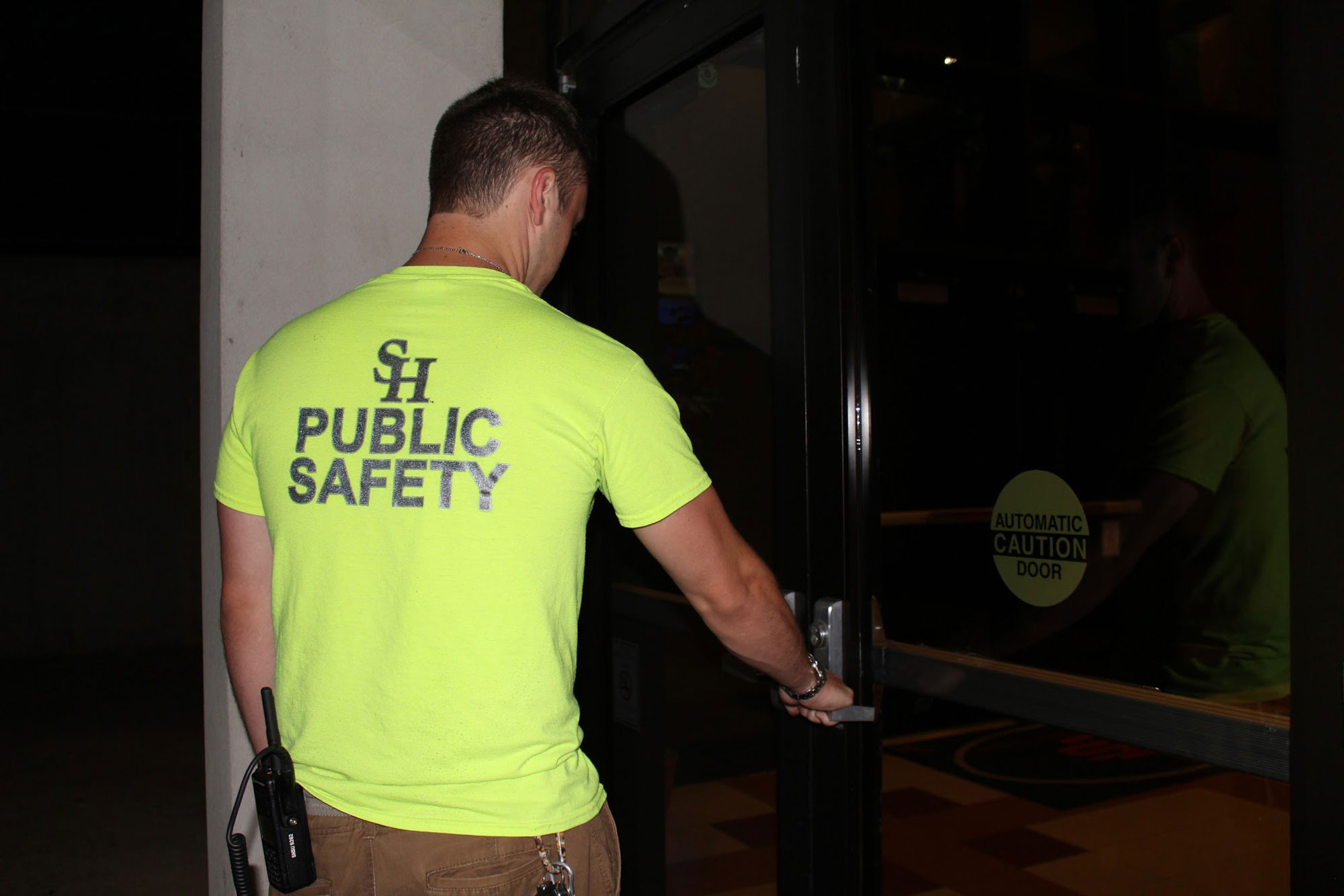 public safety student assistant approaching a door