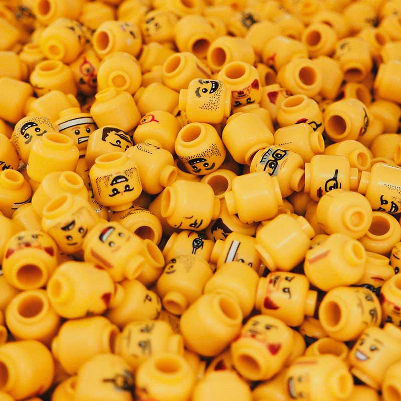 Photo by Carson Arias, Unsplash group of yellow lego heads with varying faces