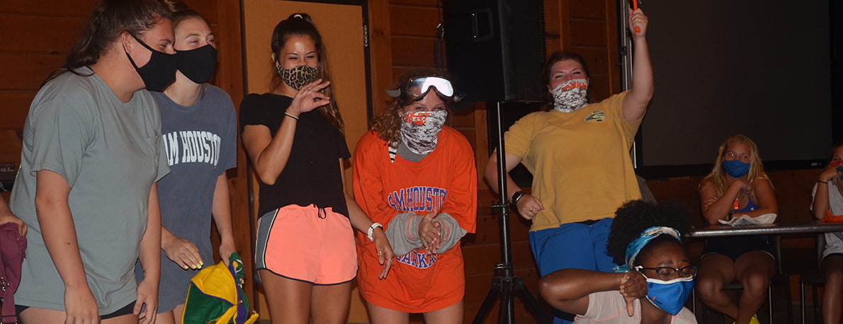 campers in lodge wearing facemasks