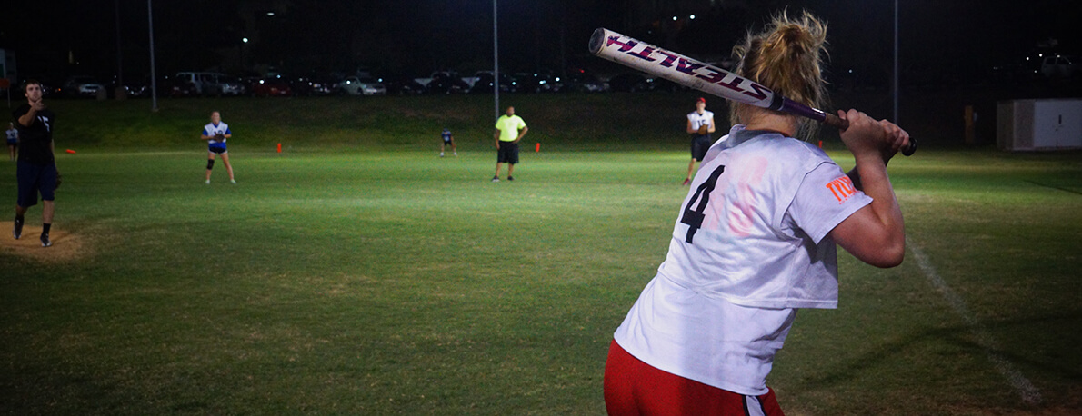 Softball batter about to hit a ball