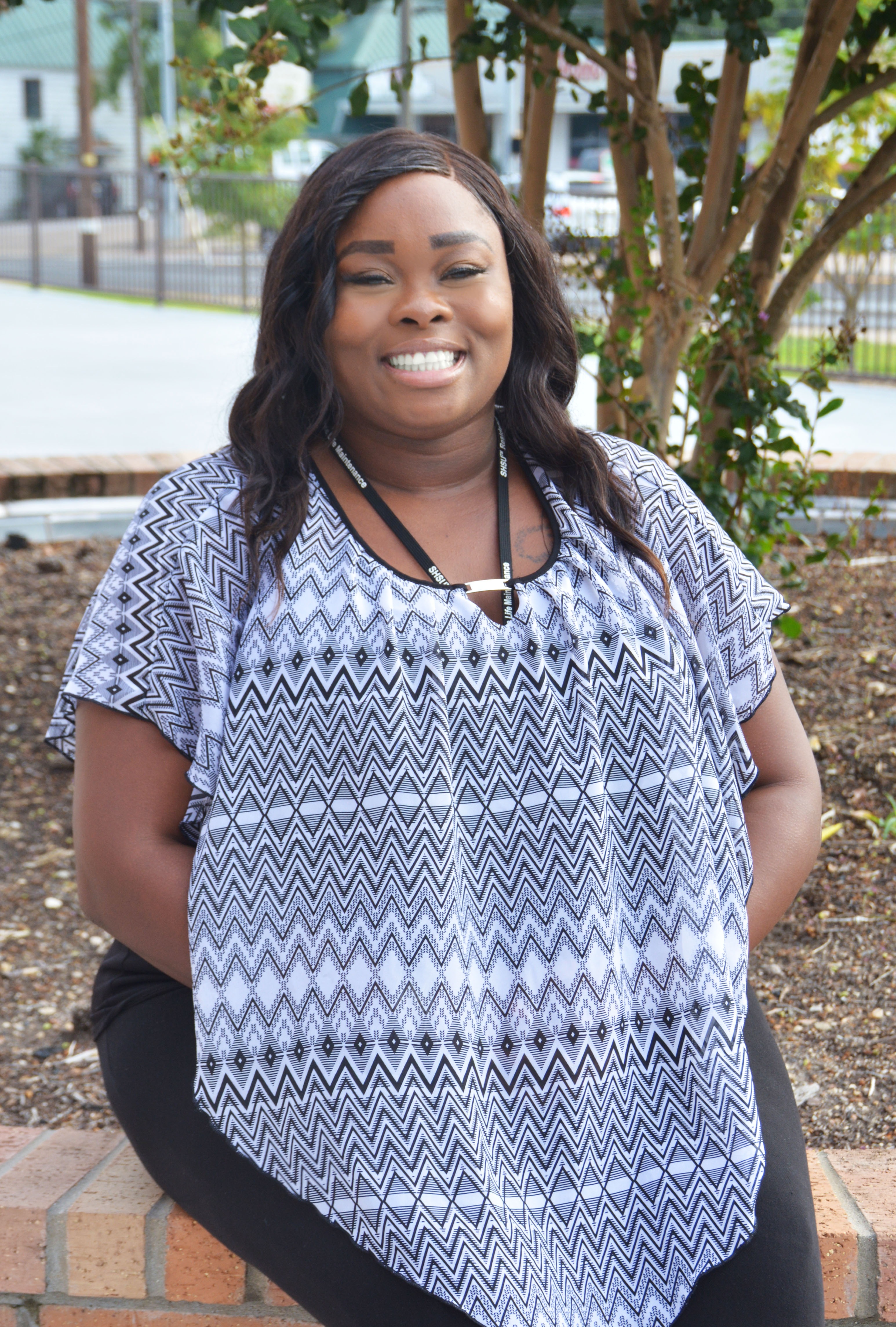 LaTasha Lewis sits posing for a photo.