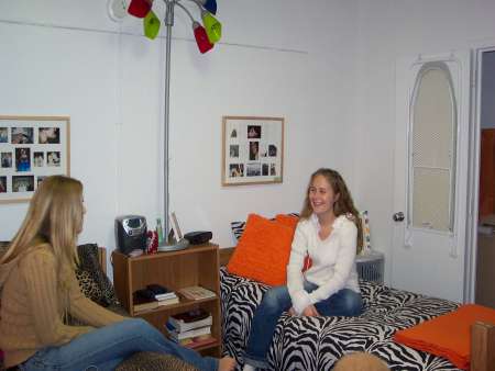 Students sitting on their beds.