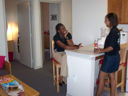 Friends sitting at the counter in the kitchen.