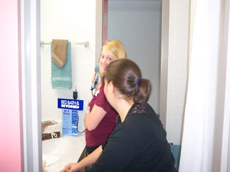 Students standing in front of their vanity.