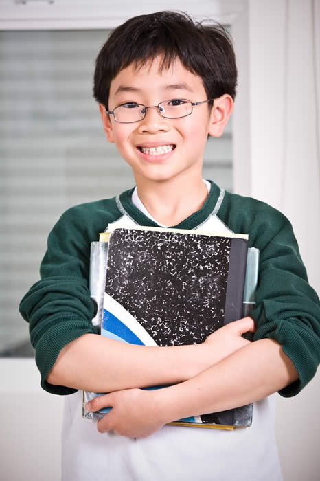 Young Asian student holding his books