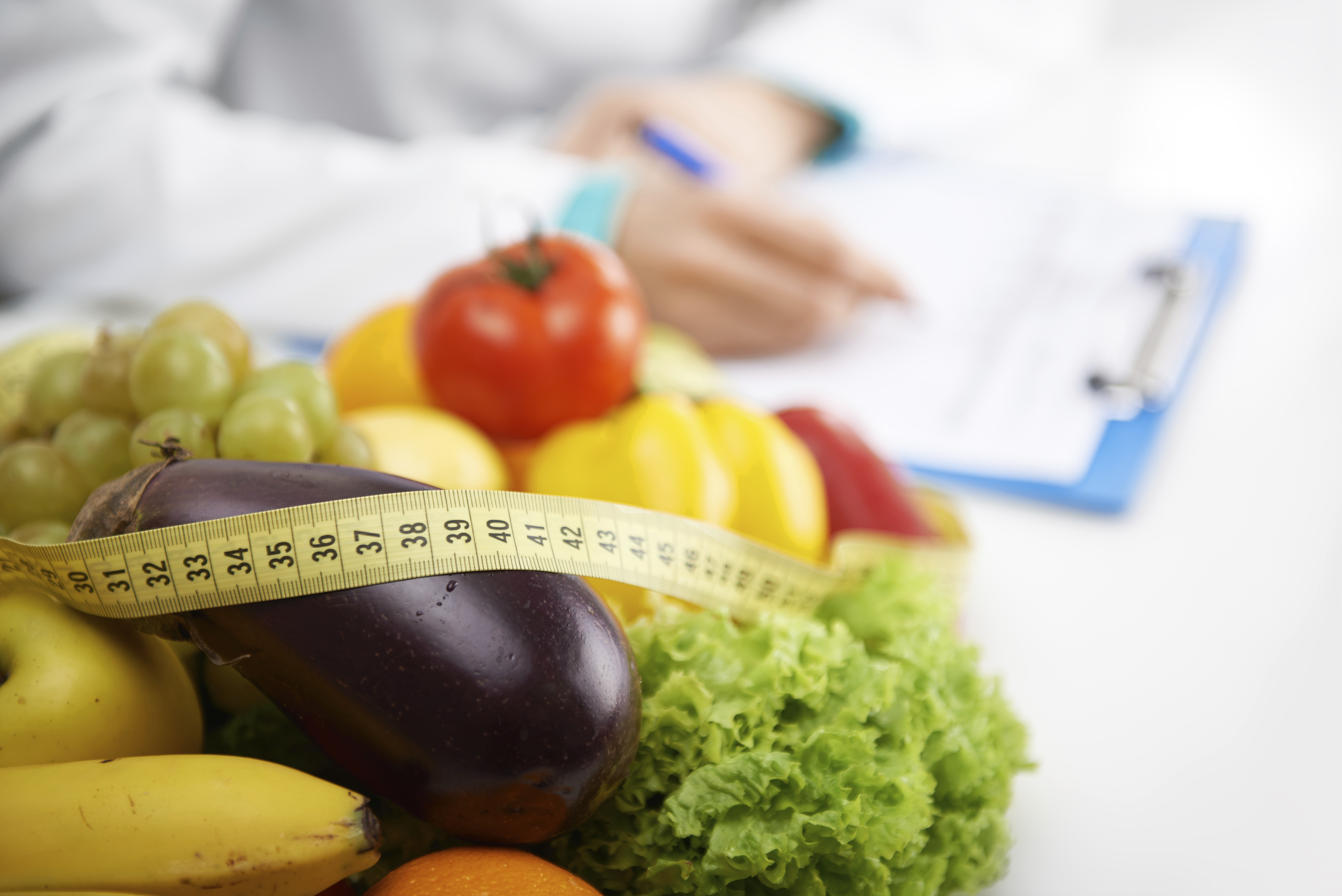 Fruits on table with tape measure