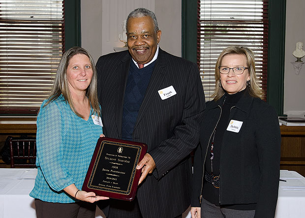 Cindy Albright, Frank Parker, and Debbie Nichols posing with their award plaque