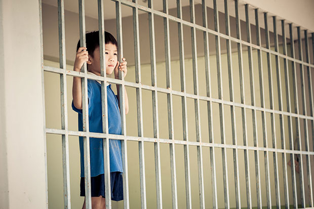 Child behind prison bars