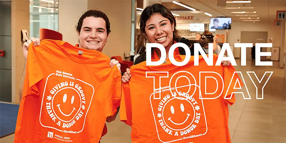 Two people holding bright orange t-shirts with a smiley face and text reading ‘San Antonio College, GIVING IS GROOVY, THANK A DONOR DAY,’ with a ‘DONATE TODAY’ overlay.