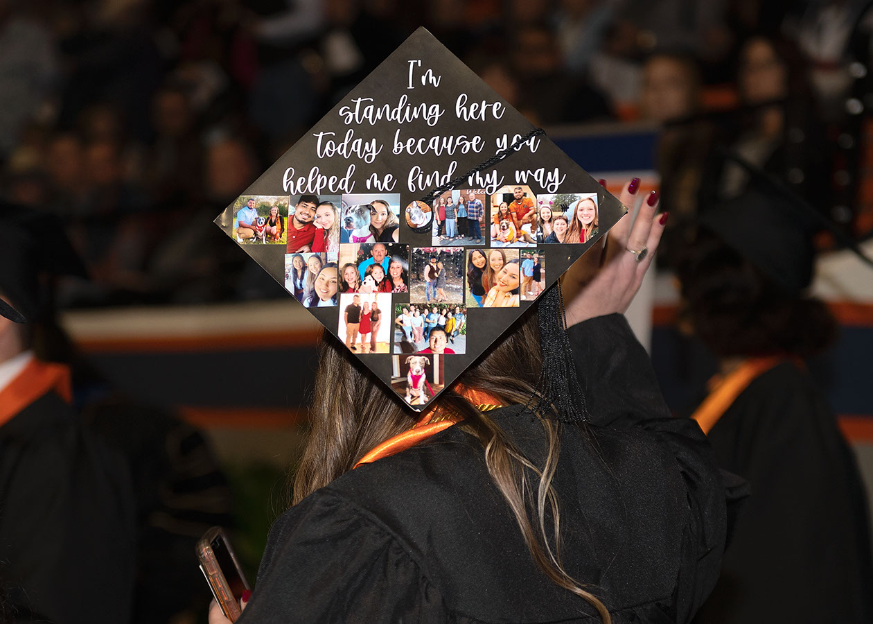 A mortarboard containing family photos and a quote that states, I'm standing here today because you helped me find my way.