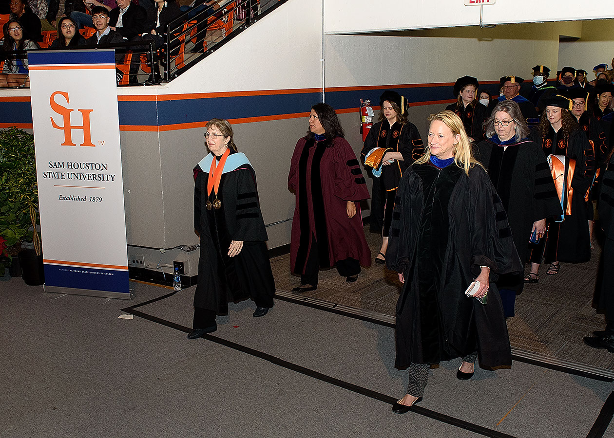 Professors enter the coliseum floor to begin the commencement ceremony.