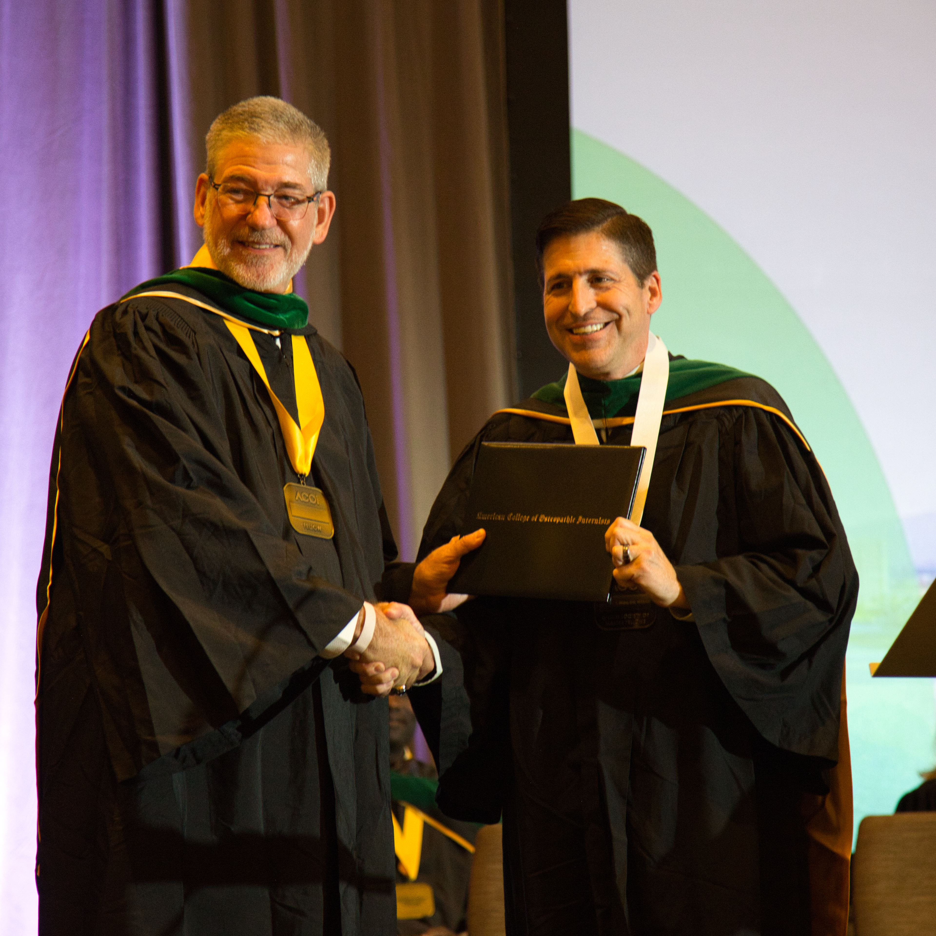 Thomas J. Mohr, DO (right) is inducted into the Gillum Society of Master Fellows.
