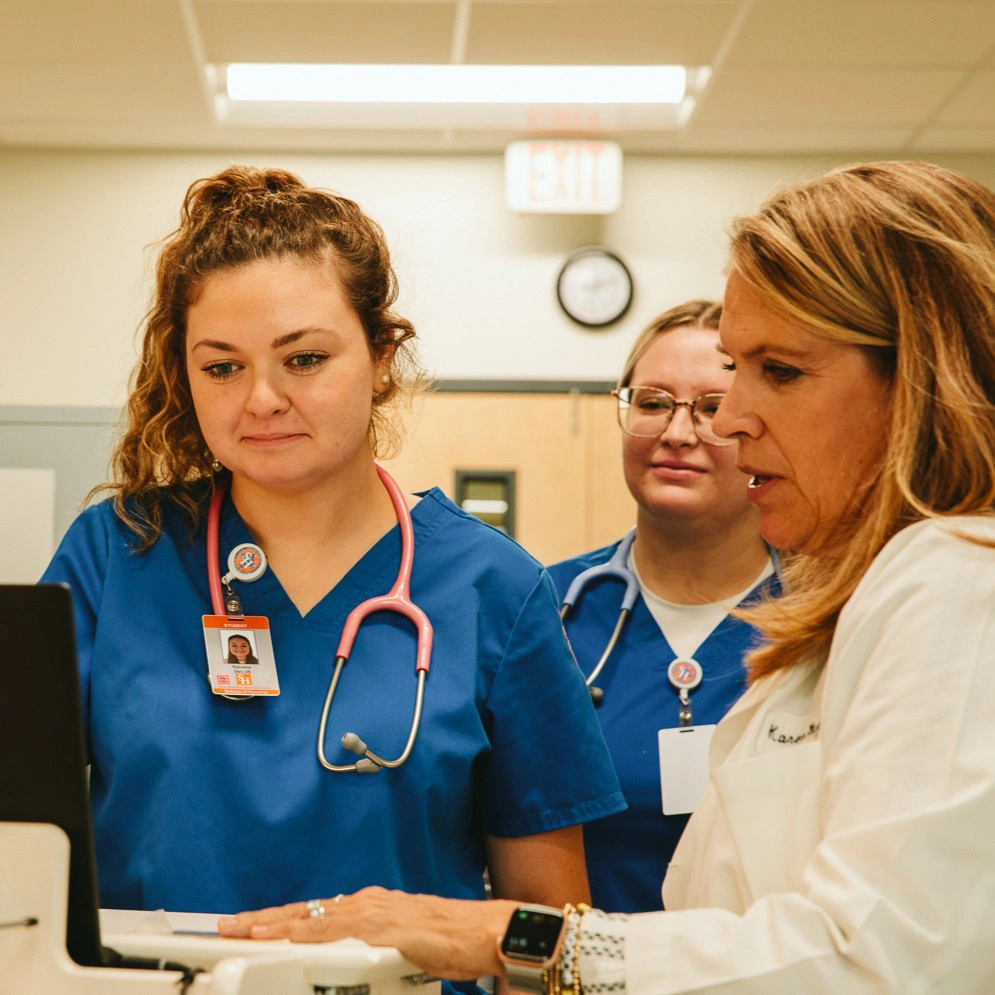 nursing student chats with professor