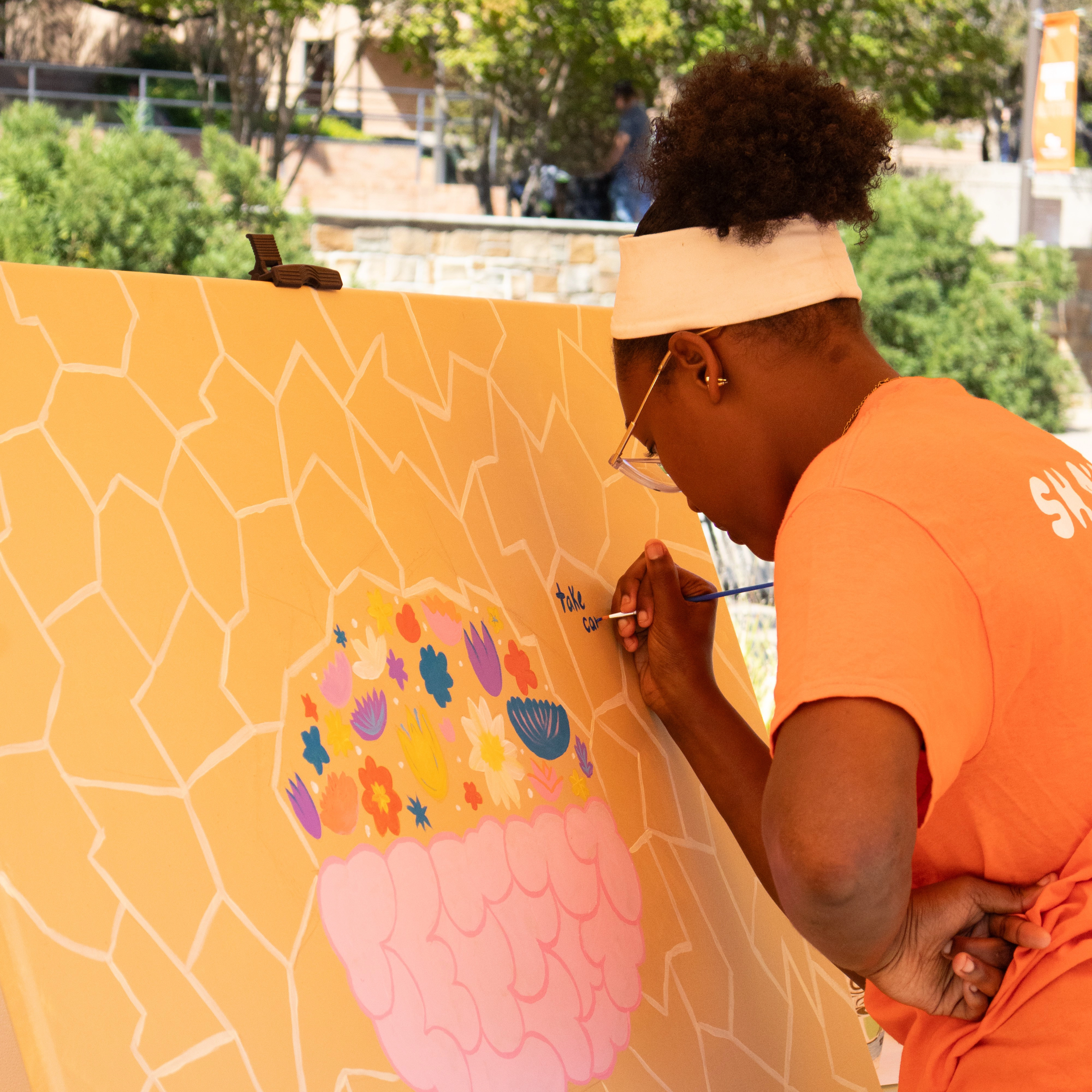 student paints canvas