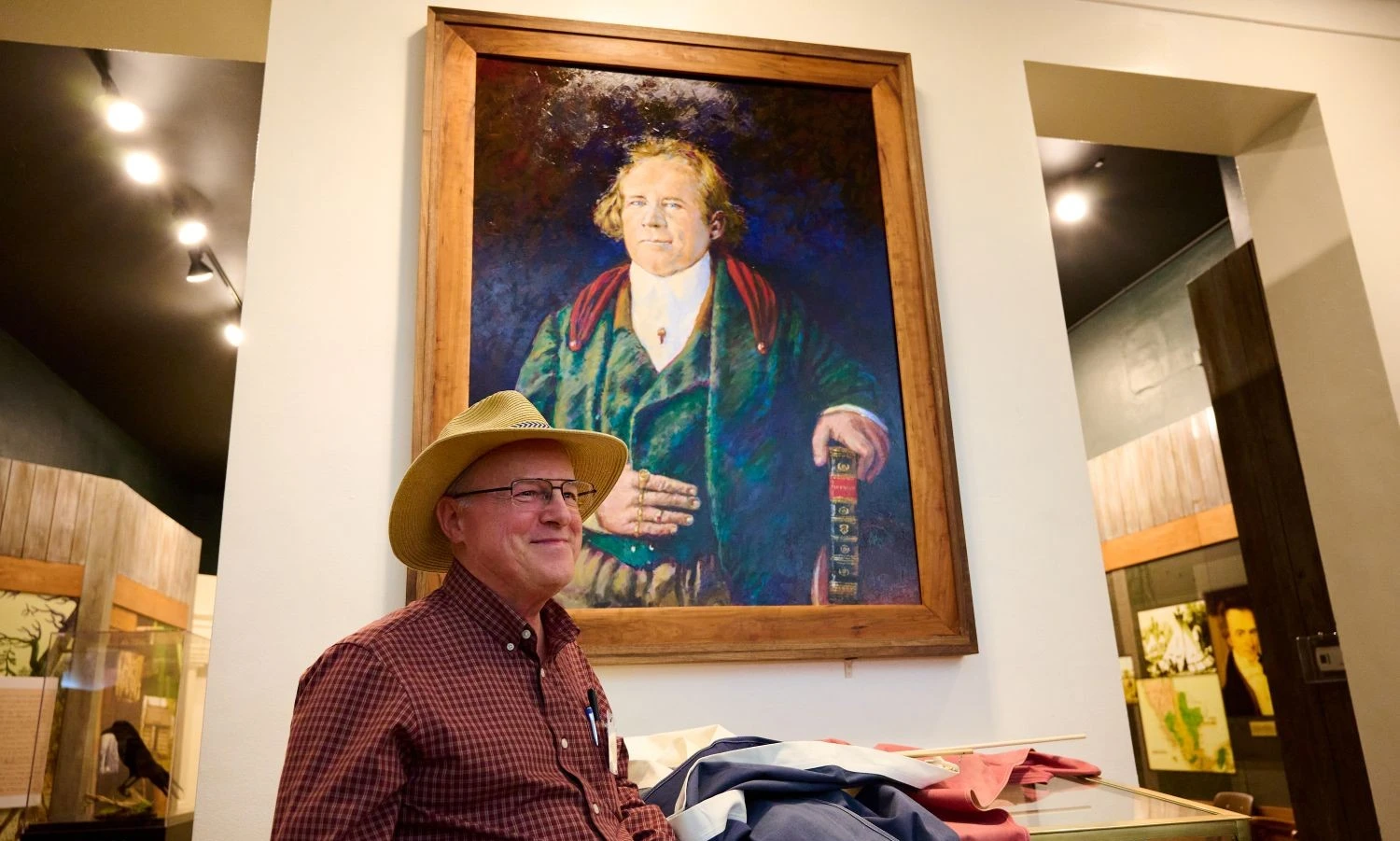 Lee Jamison in front of painting of Sam Houston.