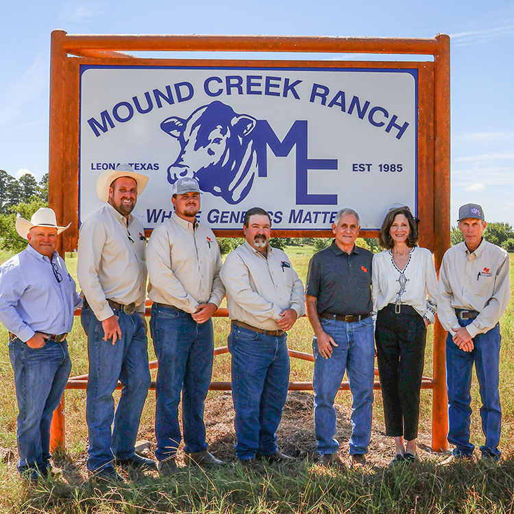 The Blazeks take a photo with Gibbs Ranch leaders beside the Mound Creek Ranch sign recently installed at Gibbs.