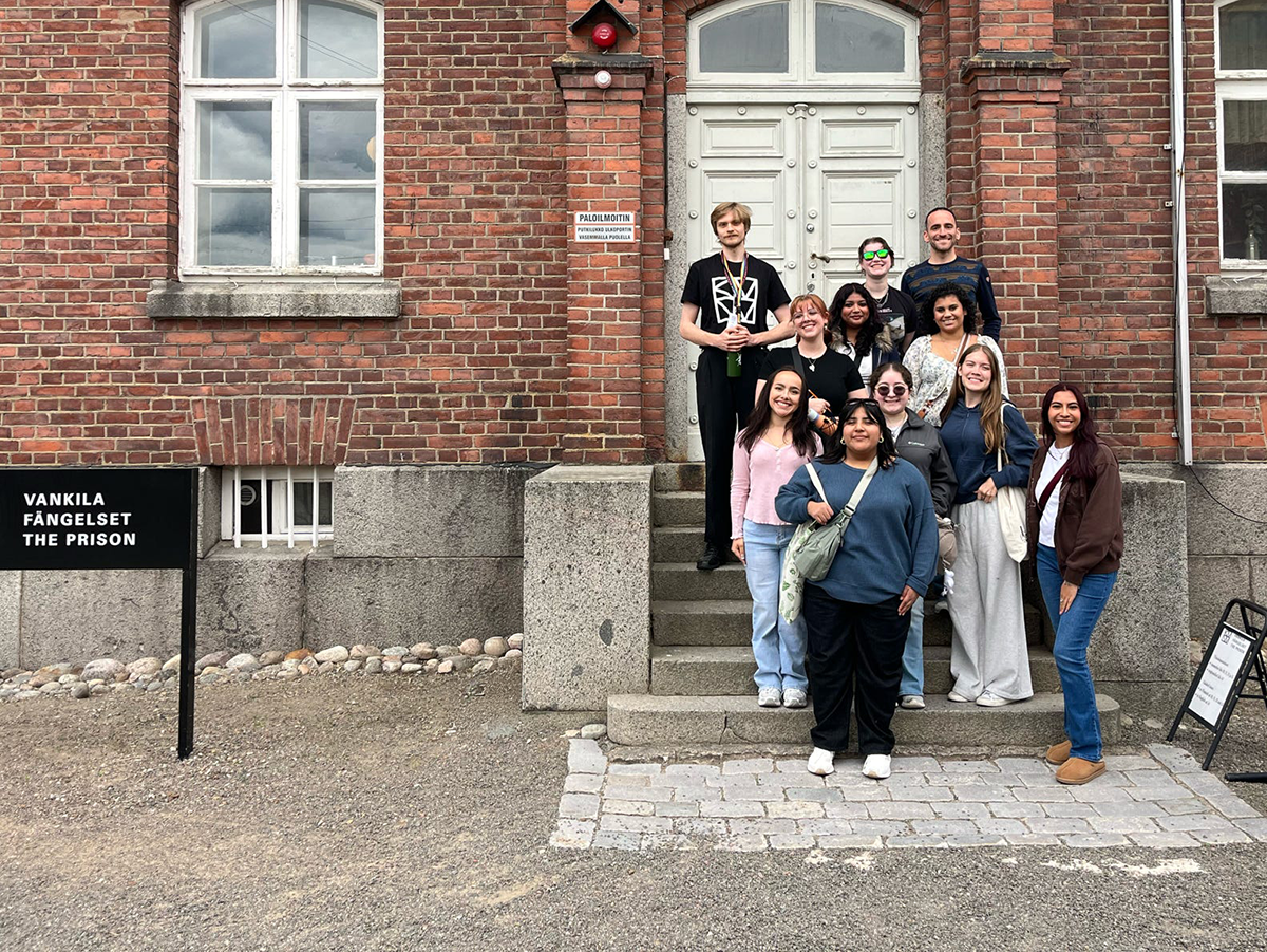 SHSU-COCJ students stand on the steps of a Finnish prison.