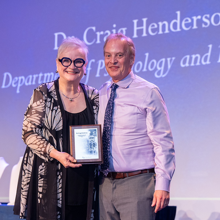 Craig Henderson with University President Alisa White. 