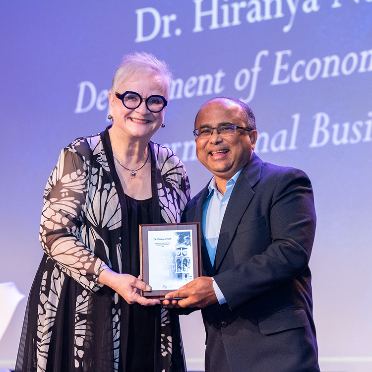 Hiranya Nath with University President Alisa White. 