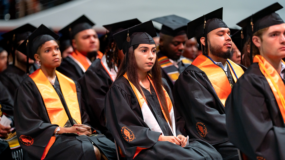 Graduates sit in Johnson Coliseum for commencement.
