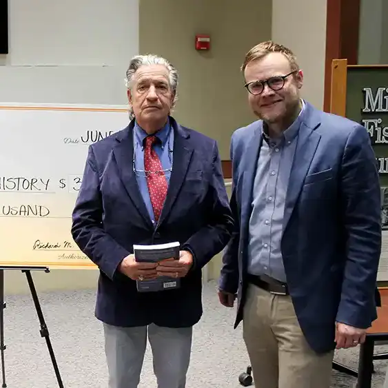Donors Richard and Cynthia Traylor pose with a giant check for $34,000 with History Department chair, Dr. Brian Jordan.