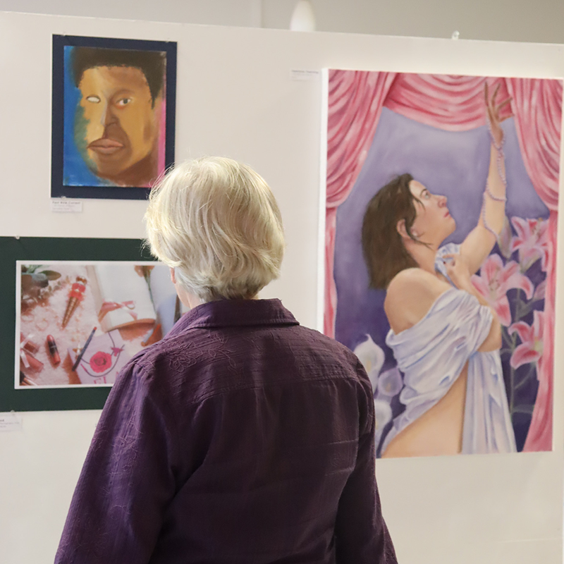 A patron of the Walking With Giants event walks through an art gallery