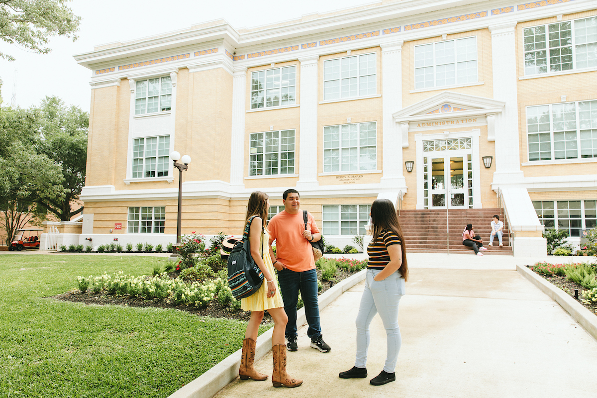 Academic building with students in front