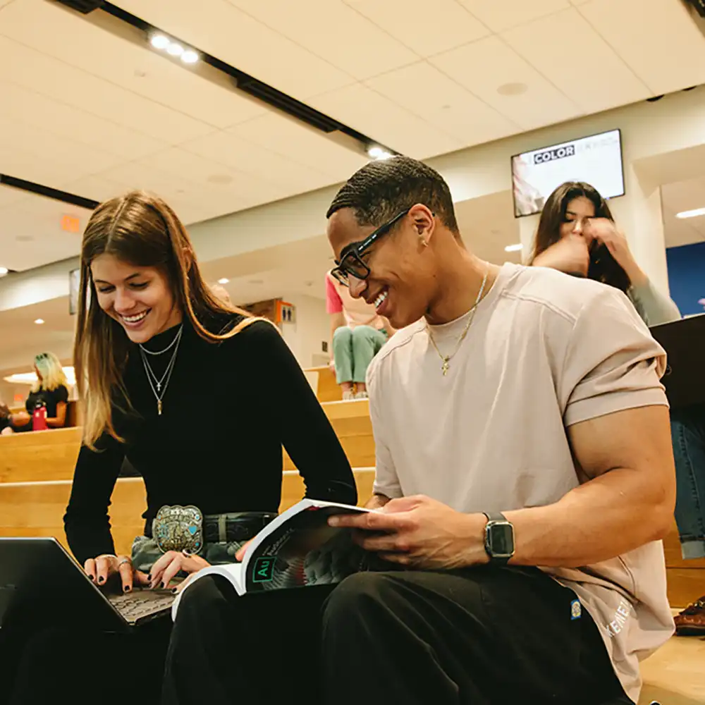 Male and female students working together.