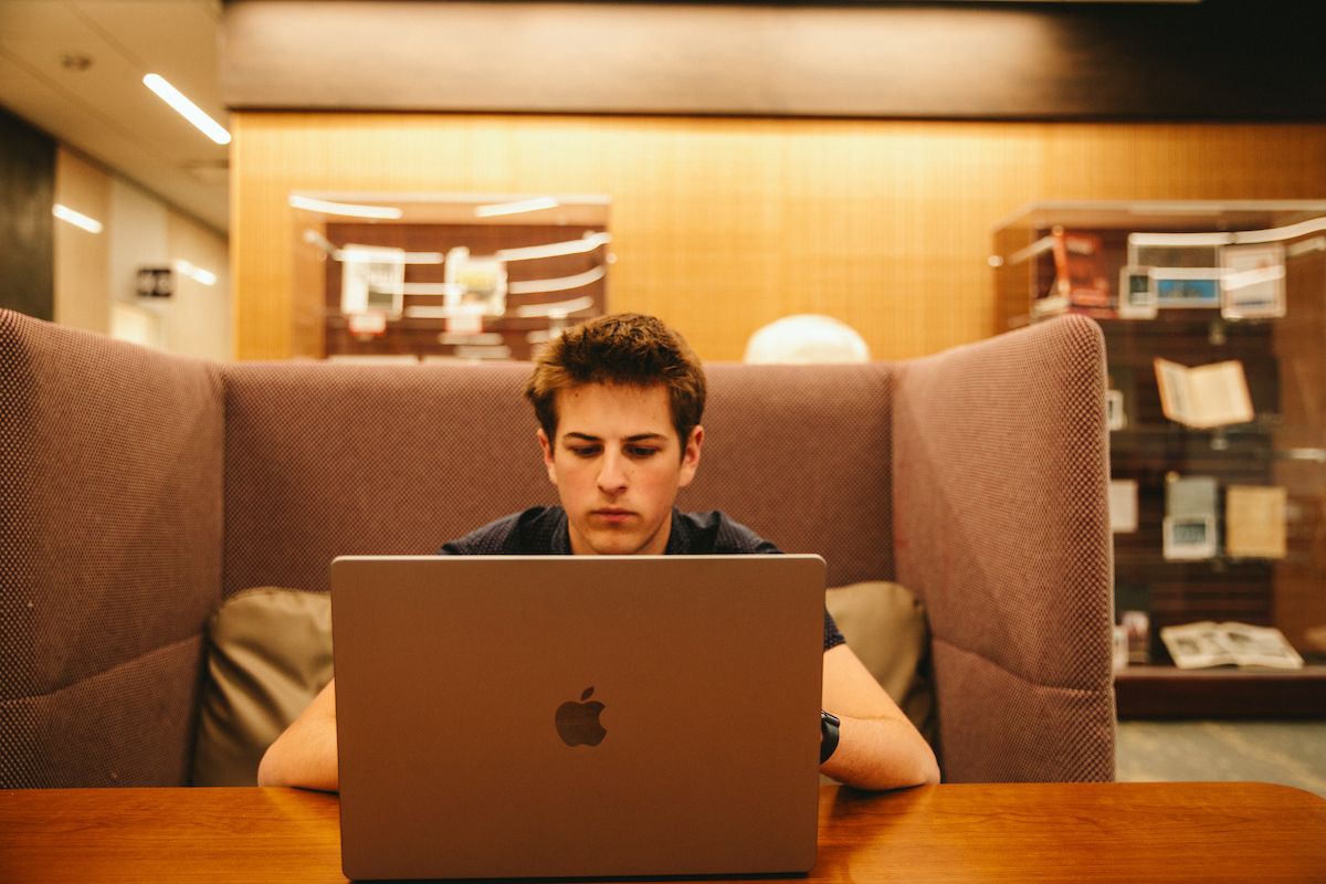 Student sitting down with a laptop
