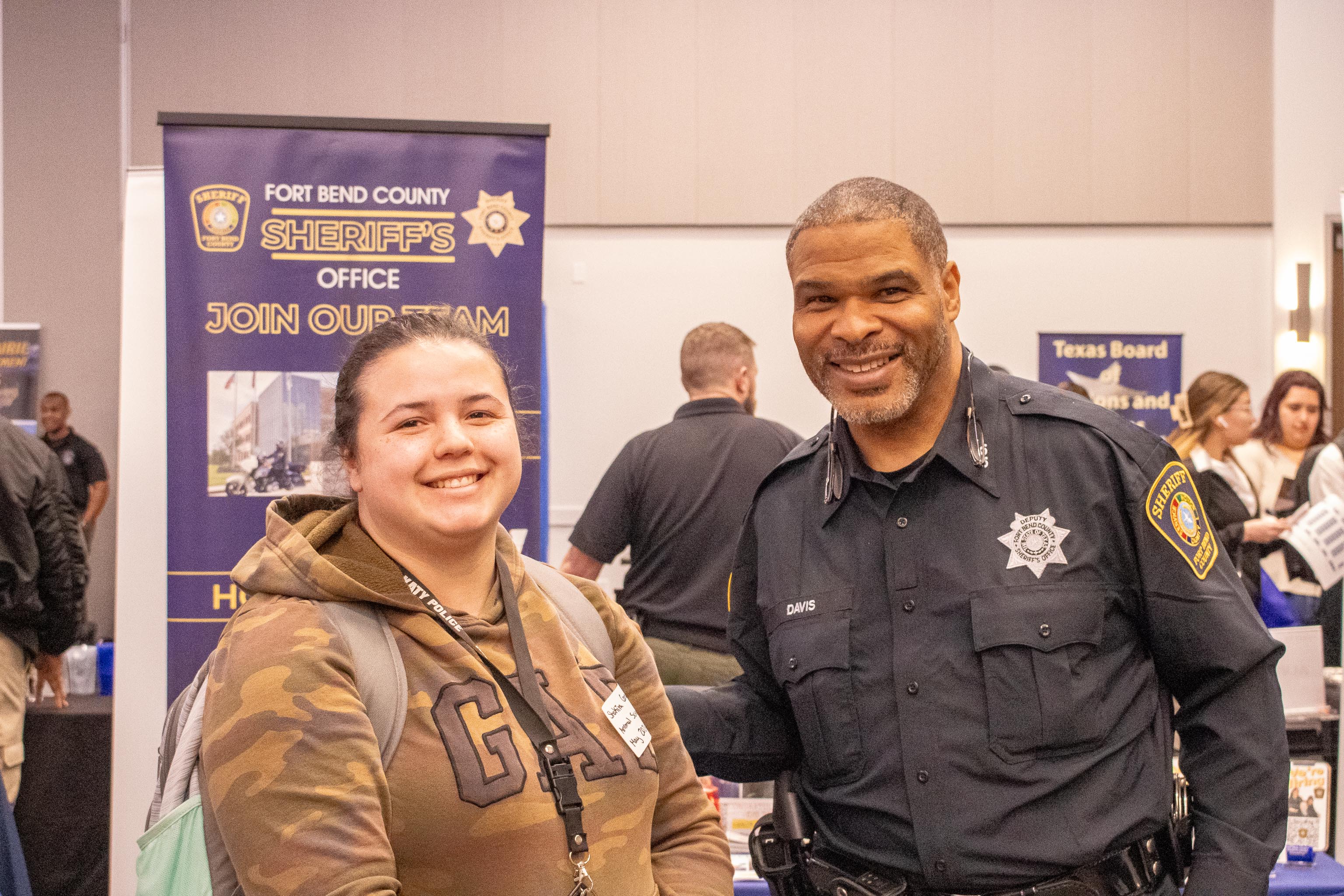 An employer posing with an SHSU student at a career fair inside the Lowman Student Center.
