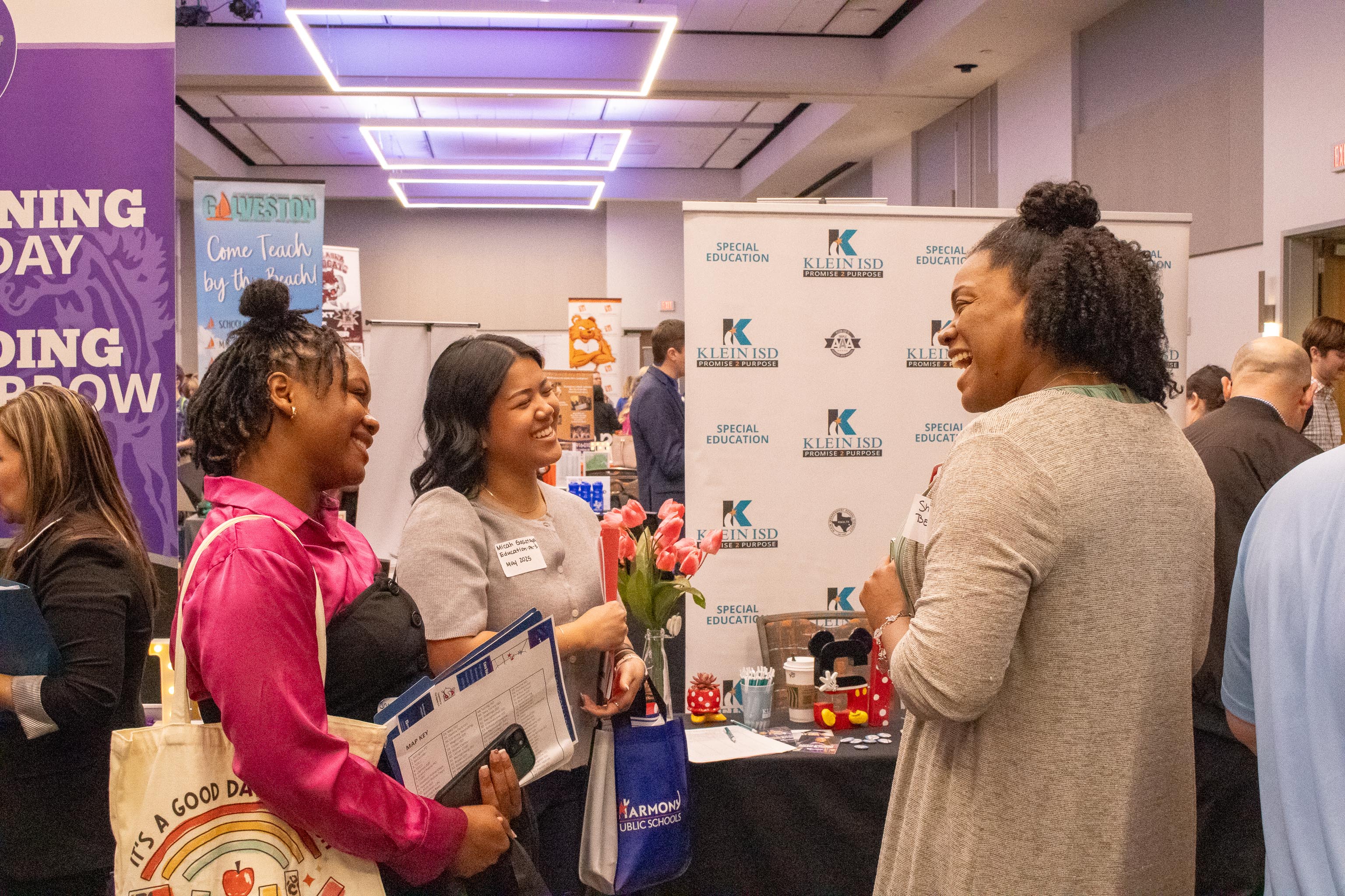 SHSU College of Education students networking with a recruiter during a career fair in the Orange Ballroom.