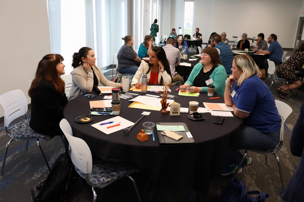 Faculty talk around table