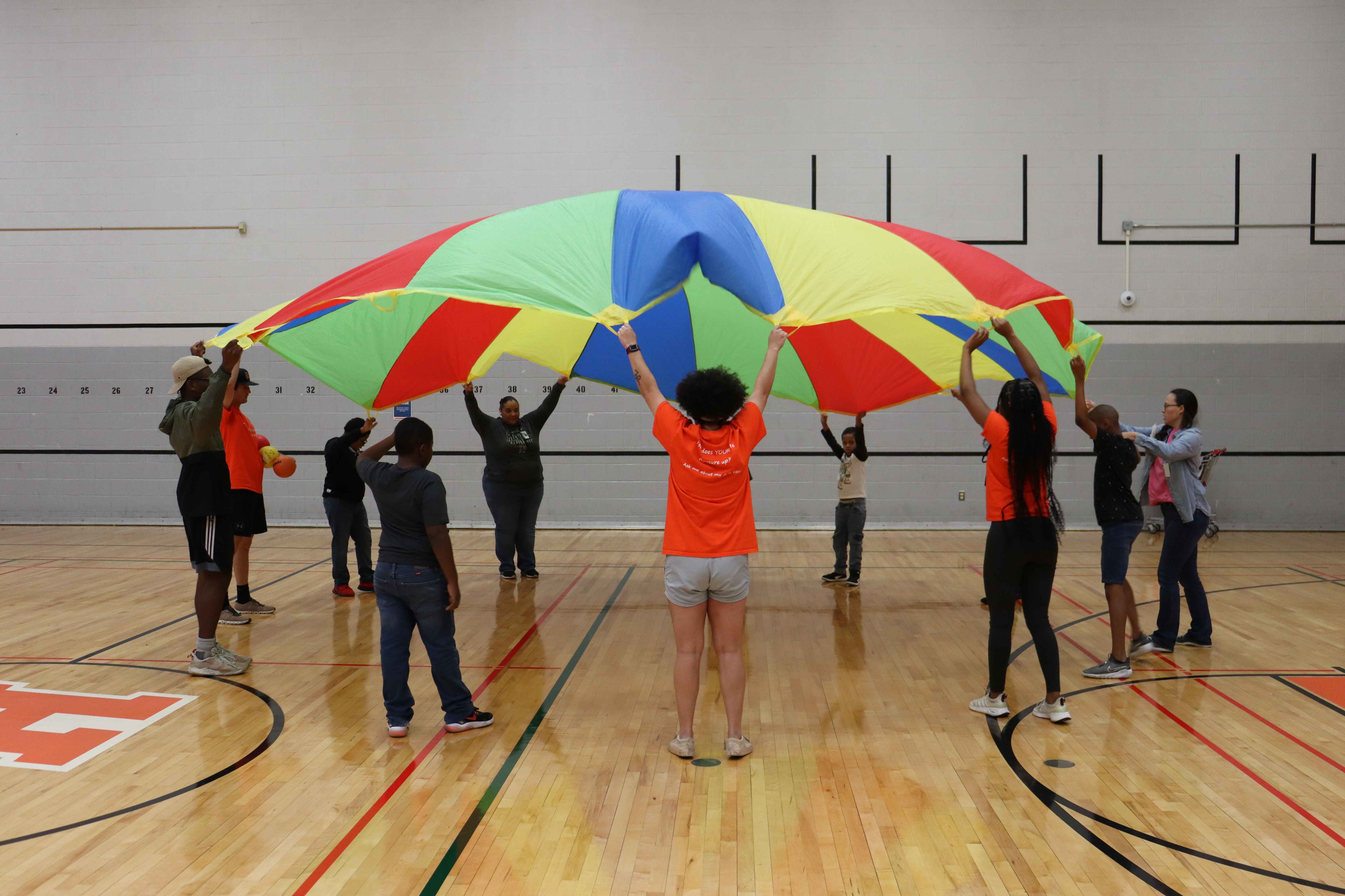 Students playing with parachute
