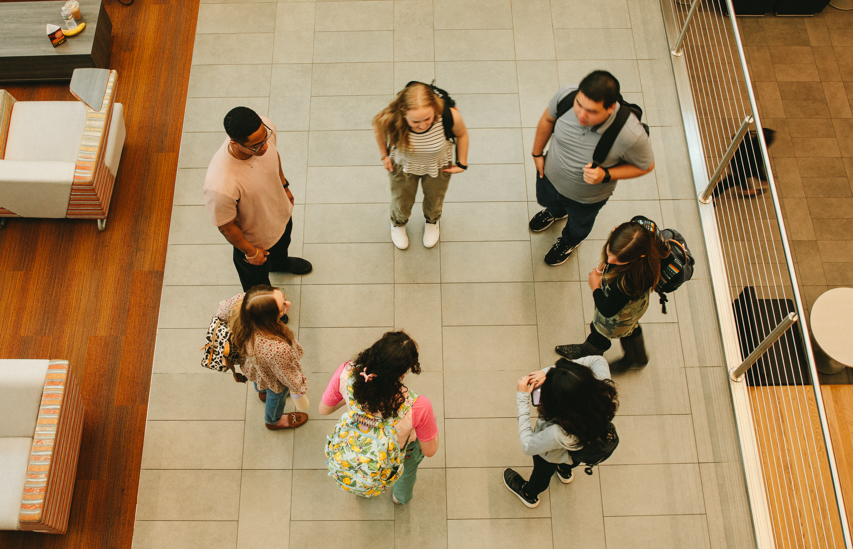 Photo of students standing in a circle talking