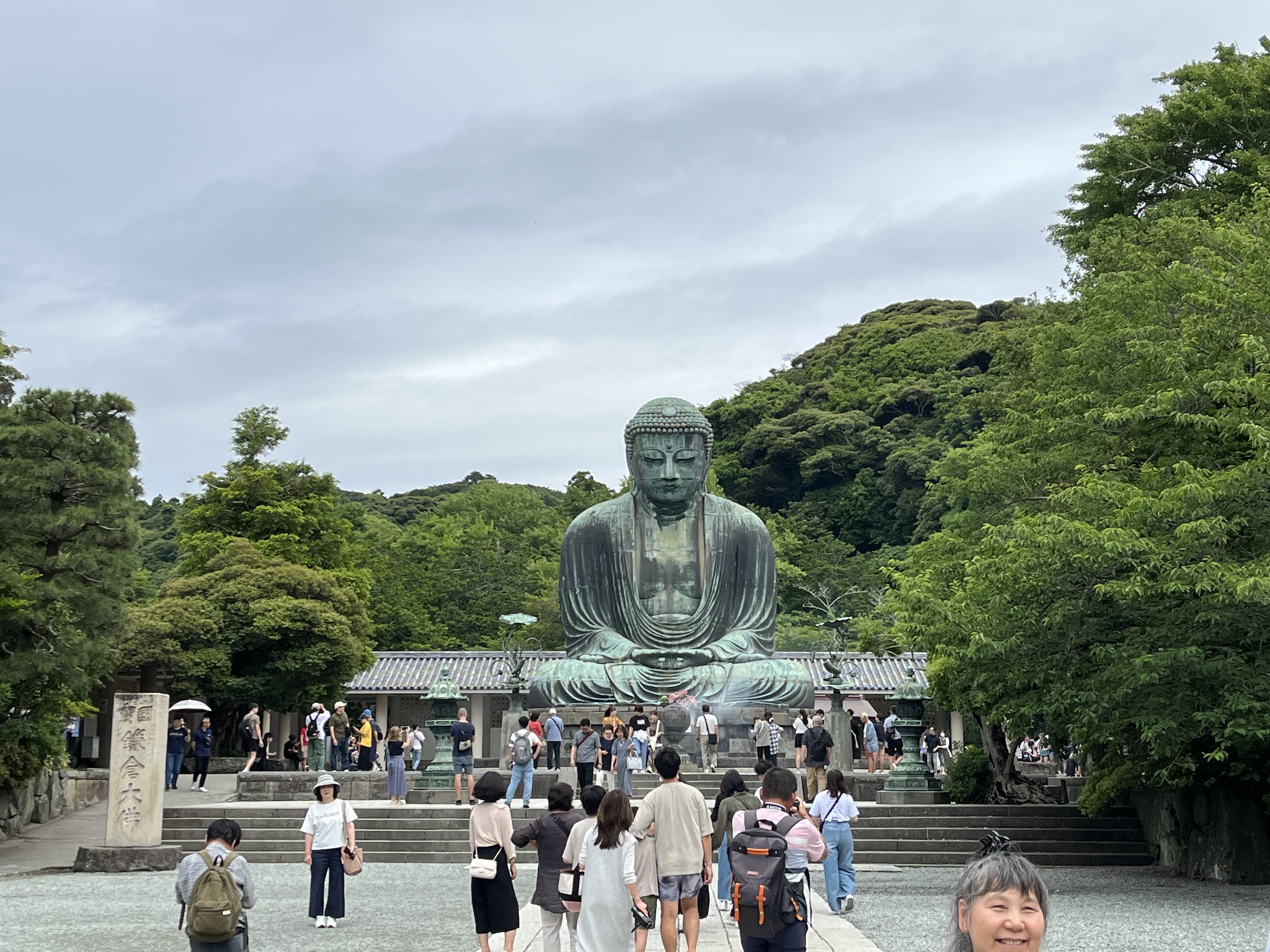 People walking around a statue