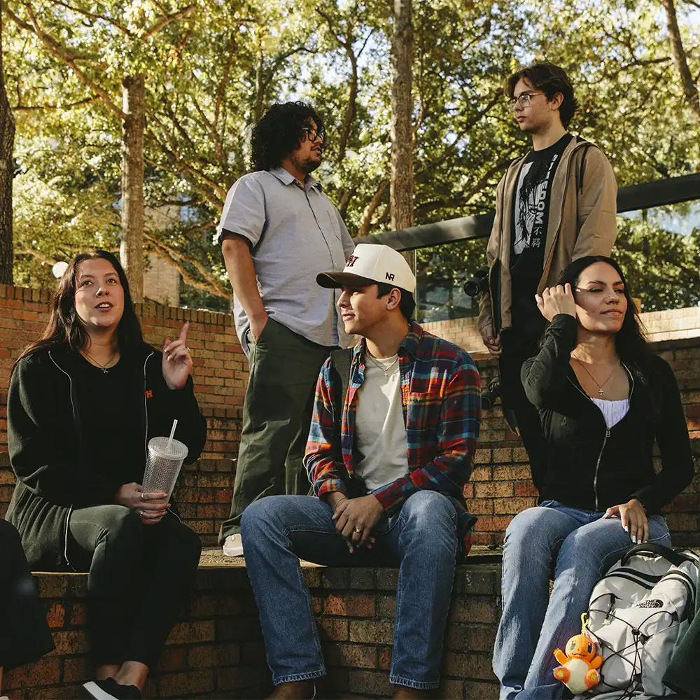 SHSU students sitting and conversing in the Frank Plaza pit.