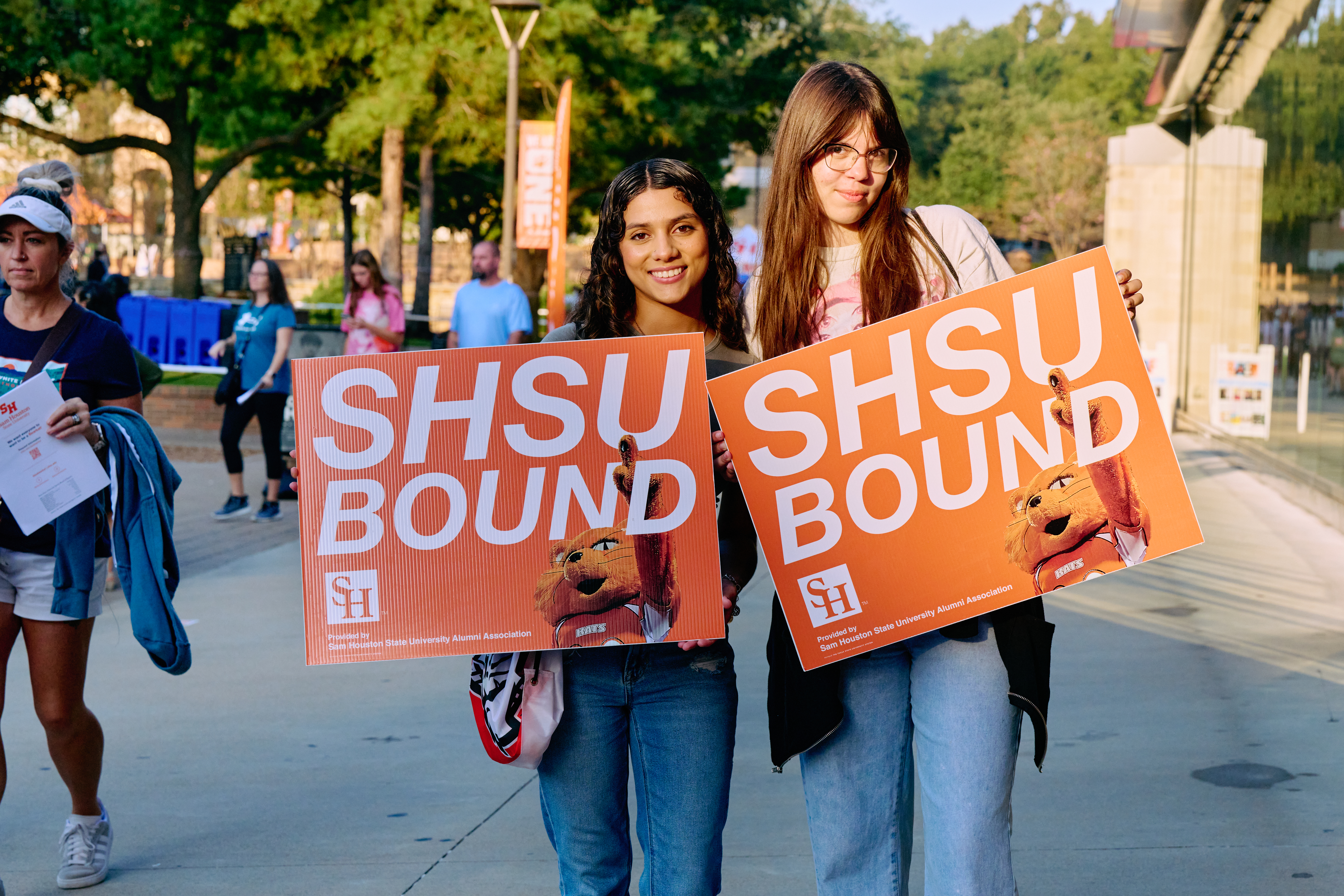 New SHSU students on campus holding signs stating “SHSU Bound”. 