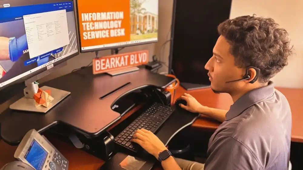 Service Desk Employee at Desk working