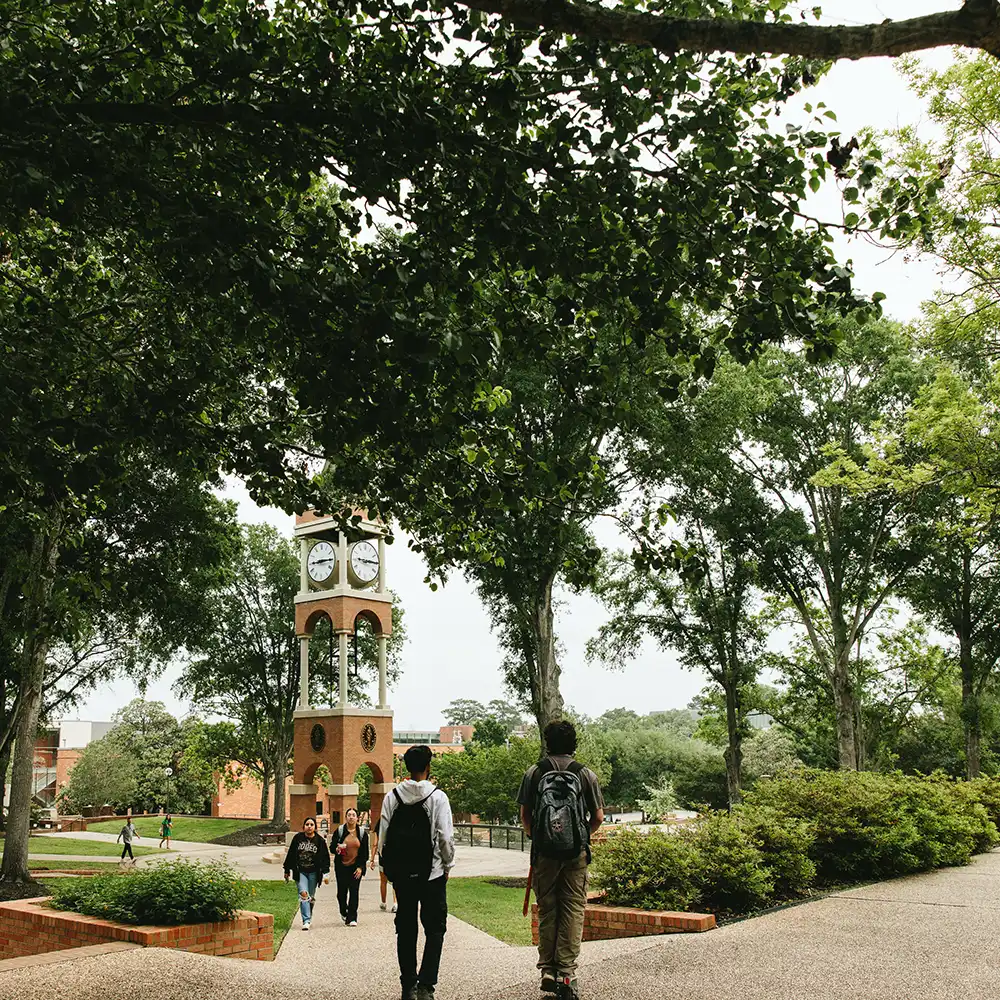 students walking towards the bell tower