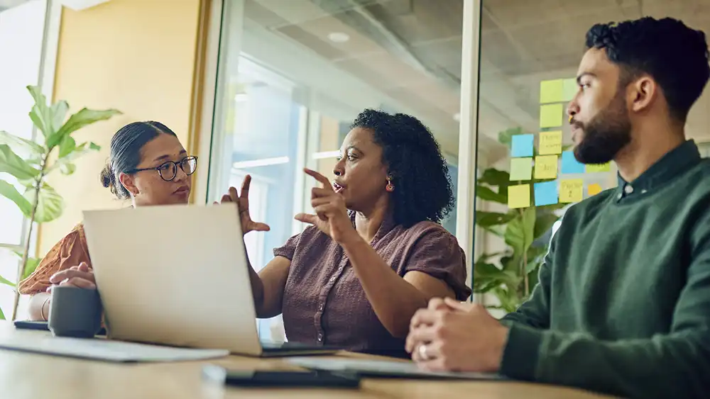 Three people working together on research.