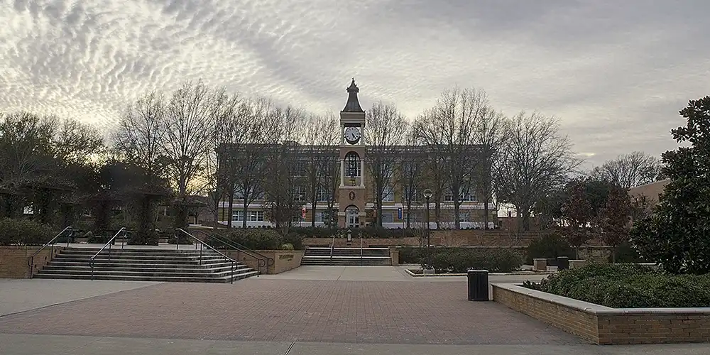 Sam Houston State University Bell Tower and Administration Building with an overcast of clouds.