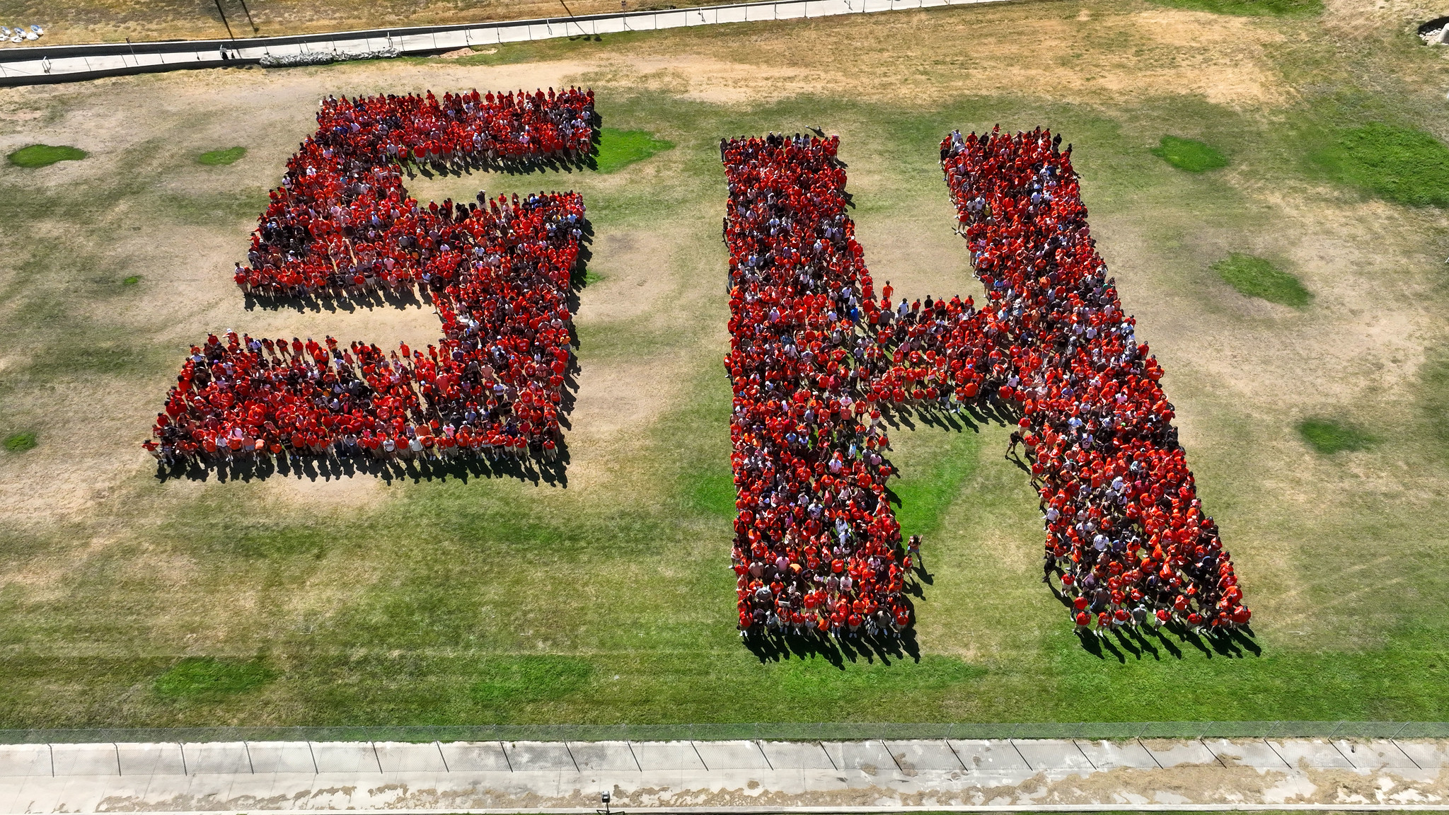 Aerial view of Sam Houston State Students assembled to create an SH