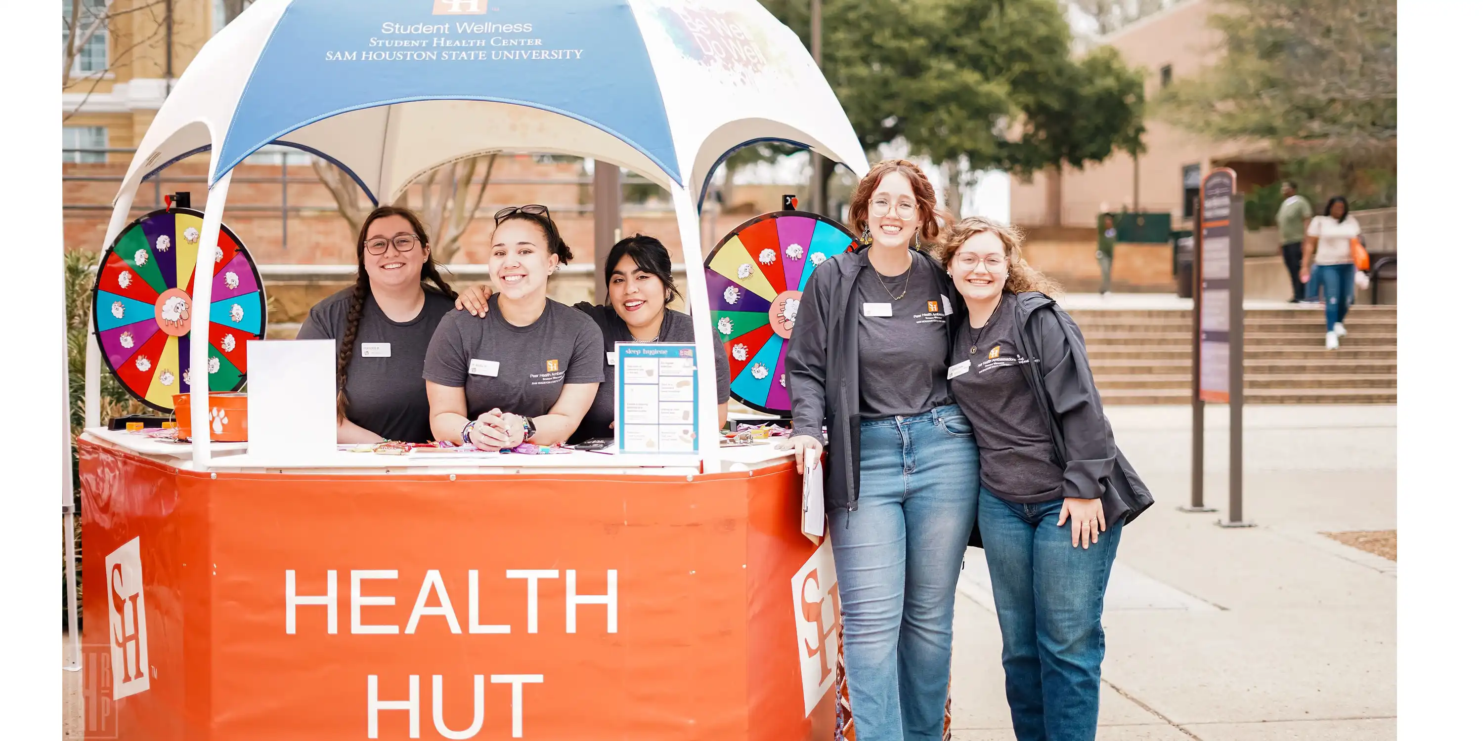 Photo of 2023-2024 Peer Health Ambassadors inside of a gazebo called the Health Hut. Left to right: Haylee, Krista, Sofia, Emily, and Kaitlyn.