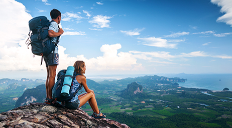 man and woman on mountain looking out to land