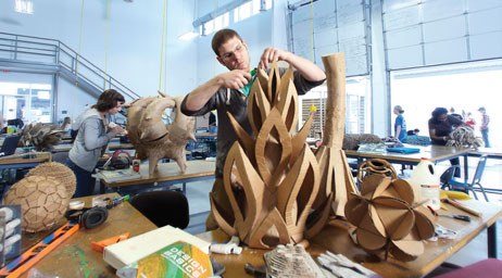 Students are crafting sculptures in an art studio.