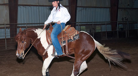 A female student riding a horse.