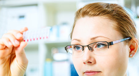 girl looking at a test tube